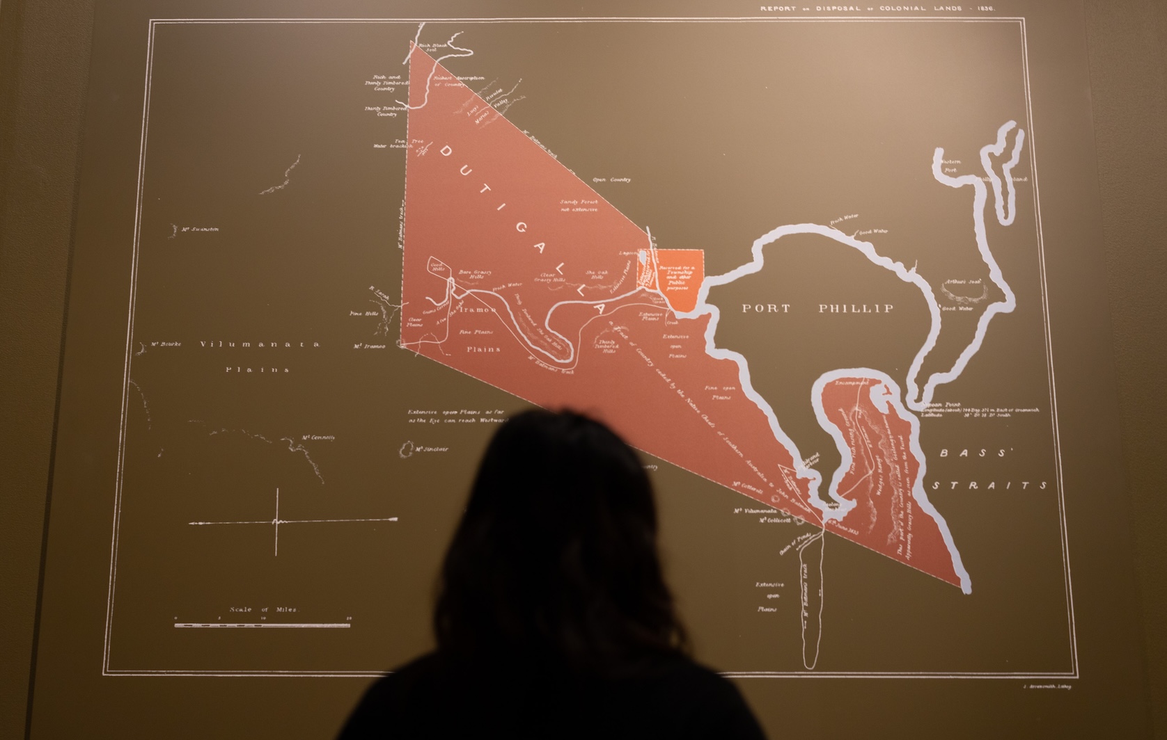 A person standing in front of a map within the Treaty exhibition space