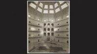 black border with sepia photo of domed reading room under construction