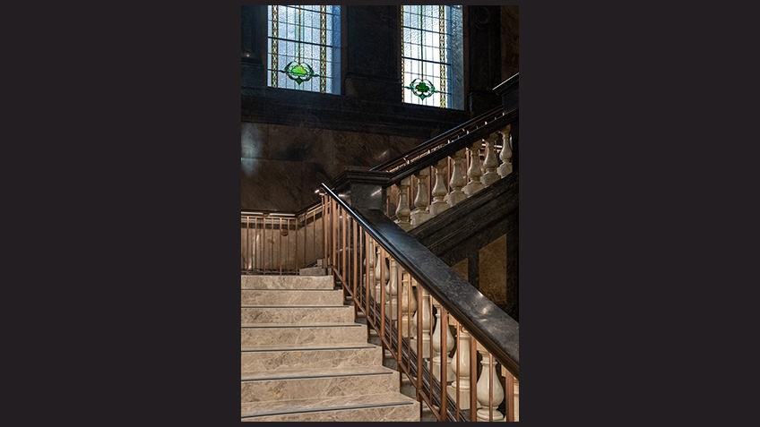 marble staircase with stained-glass windows