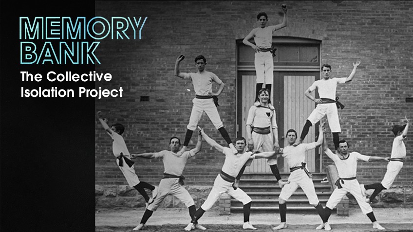 Eight men in white outfits support each other in a human pyramid