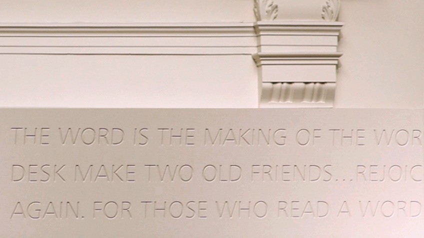 Inscribed words on a white wall