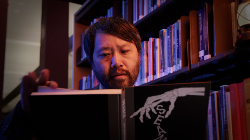 Image of Lawrence Leung reading a book.